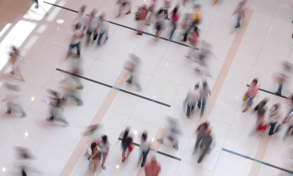 Crowd walking through a shopping centre, a public place covered by public liability law